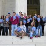 Honors College students in Washington D.C. holding Brescia fans in 2016