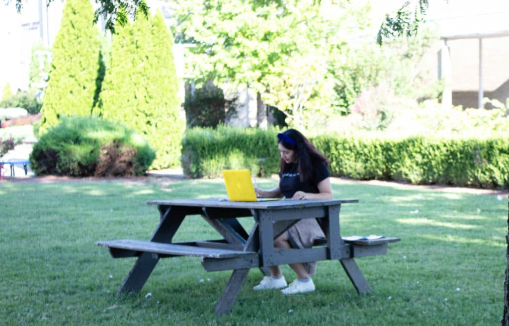 Student studying in the quad.