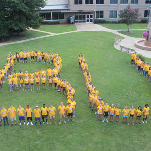 Students forming a B and U