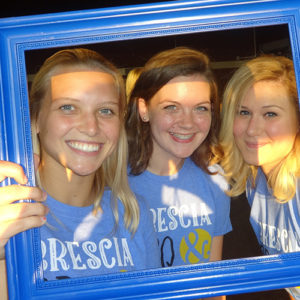 Students holding a blue frame